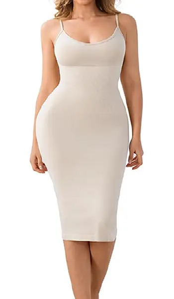 Woman wearing a beige spaghetti strap shapewear full slip dress with a seamless, figure-hugging midi bodycon silhouette.