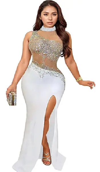 Woman wearing a white sleeveless evening dress featuring a sheer mesh top covered in sparkling rhinestones, a high mock neck, and a front slit skirt.