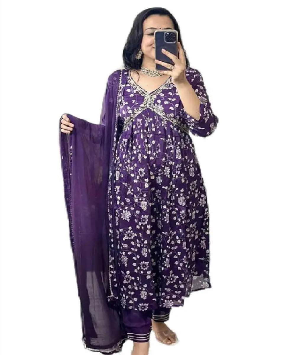 A woman wearing a black georgette Anarkali-style kurta with intricate embroidery, paired with matching pants and a dupatta.