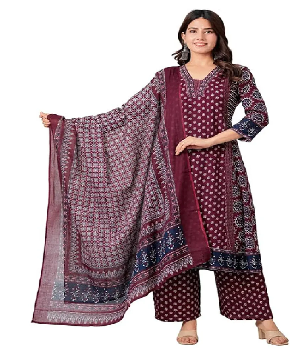 A woman wearing a vibrant red Anarkali-style kurta with gold-tone floral print detailing, paired with matching pants and a decorative dupatta.
