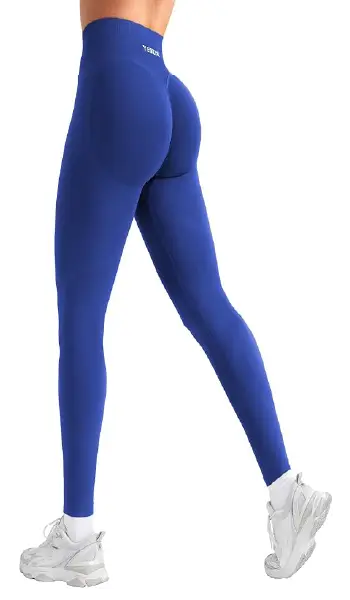 A woman modeling blue, high-waisted seamless leggings with a subtle glute-contouring design.