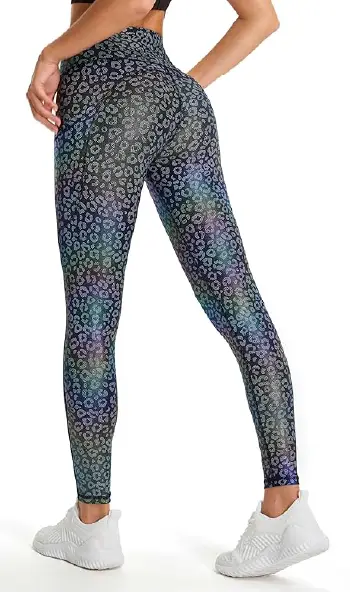 A woman modeling high-waisted, leopard print leggings with a holographic finish, featuring side pockets and back waistband storage.