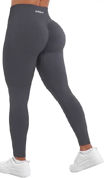 A woman modeling grey AUROLA seamless, mid-rise leggings with a scrunch-butt design.