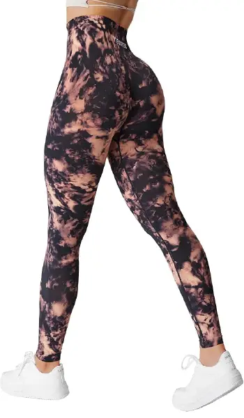 A woman modeling Yeoreo Jada high-waisted leggings with a unique black and brown "ink cloud" tie-dye print.