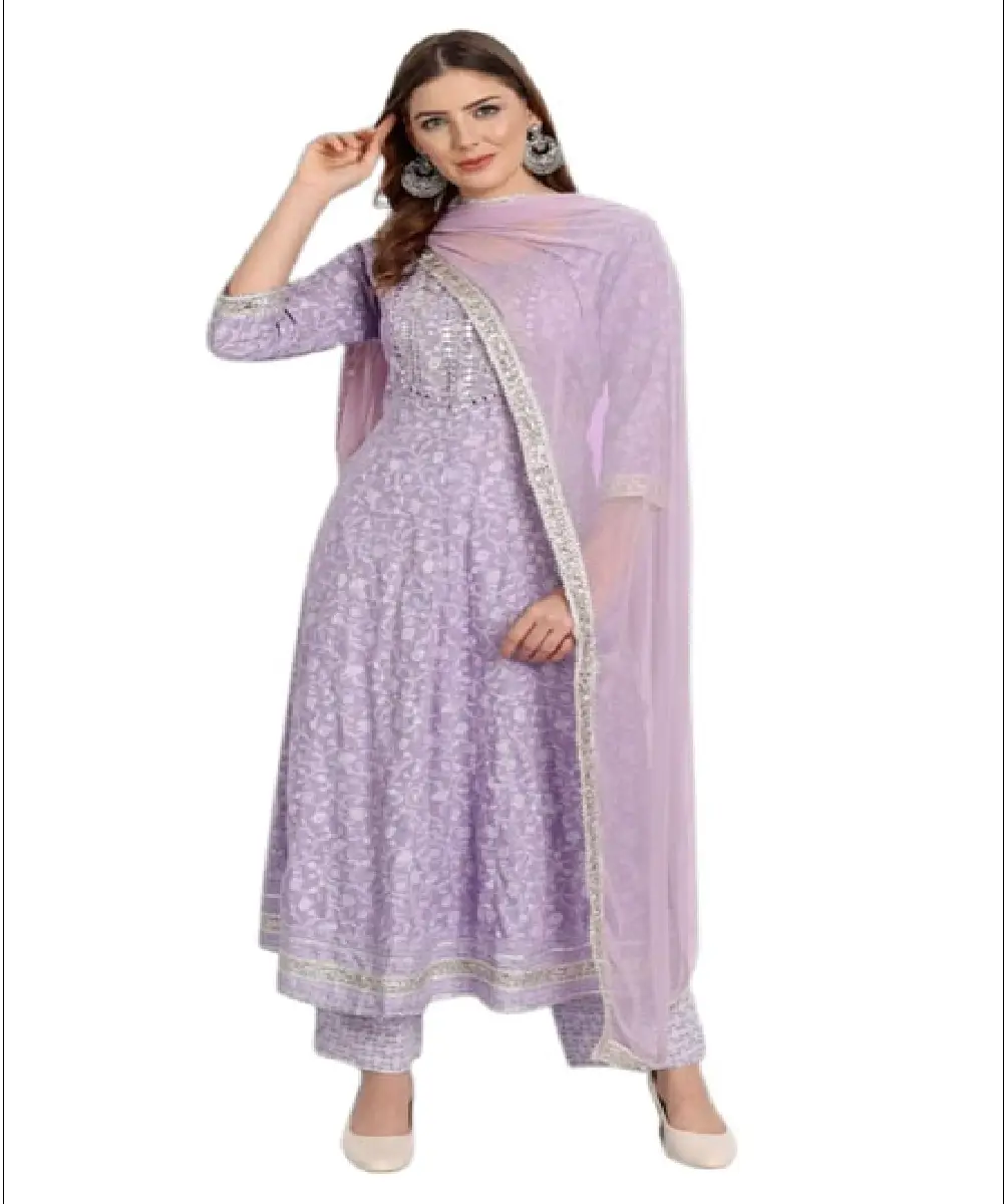 A woman wearing a bright red Anarkali-style kurta with gold-tone traditional print detailing, paired with matching pants and a dupatta.