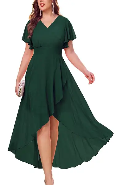 A model wearing an emerald green plus-size high-low dress featuring a V-neckline, short ruffled sleeves, and an asymmetrical skirt with a front slit.