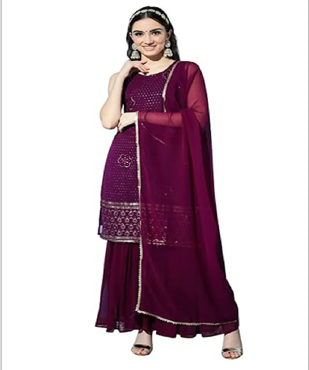 A woman wearing a bright red Anarkali-style kurta with gold-tone traditional print detailing, paired with matching pants and a dupatta.