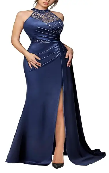 A model wearing a navy blue floor-length A-line gown with a halter neckline, see-through glitter lace patchwork bodice, and a side-slit satin skirt with a flowing flutter detail.