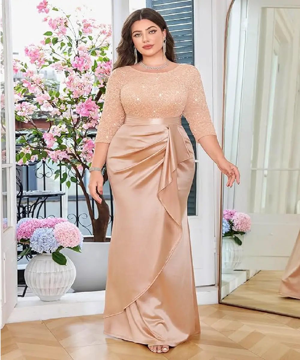 A plus size woman is wearing a gorgeous champagne colored gown, featuring a sequin lace top and satin ruched ruffle details.