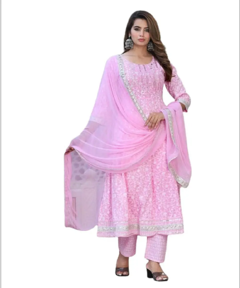 A woman modeling a soft pink, fully stitched Anarkali kurta set featuring delicate embroidery, paired with matching palazzo pants and a lightweight dupatta.