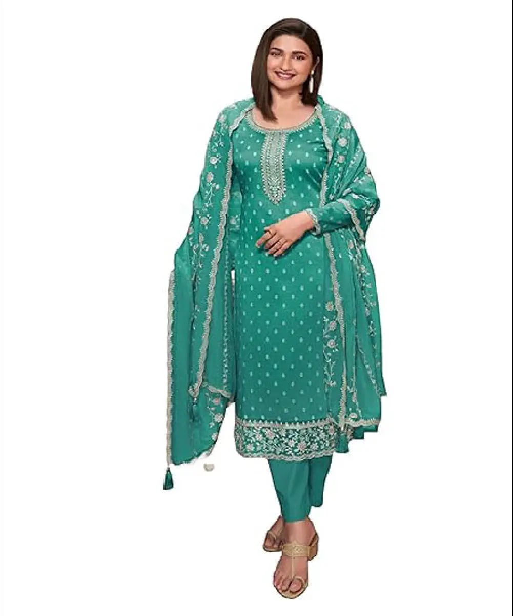A woman wearing a ready-to-wear teal heavy silk salwar kameez set featuring floral prints, sequence embroidery, round neck, full sleeves, and a matching embroidered chinon silk dupatta.