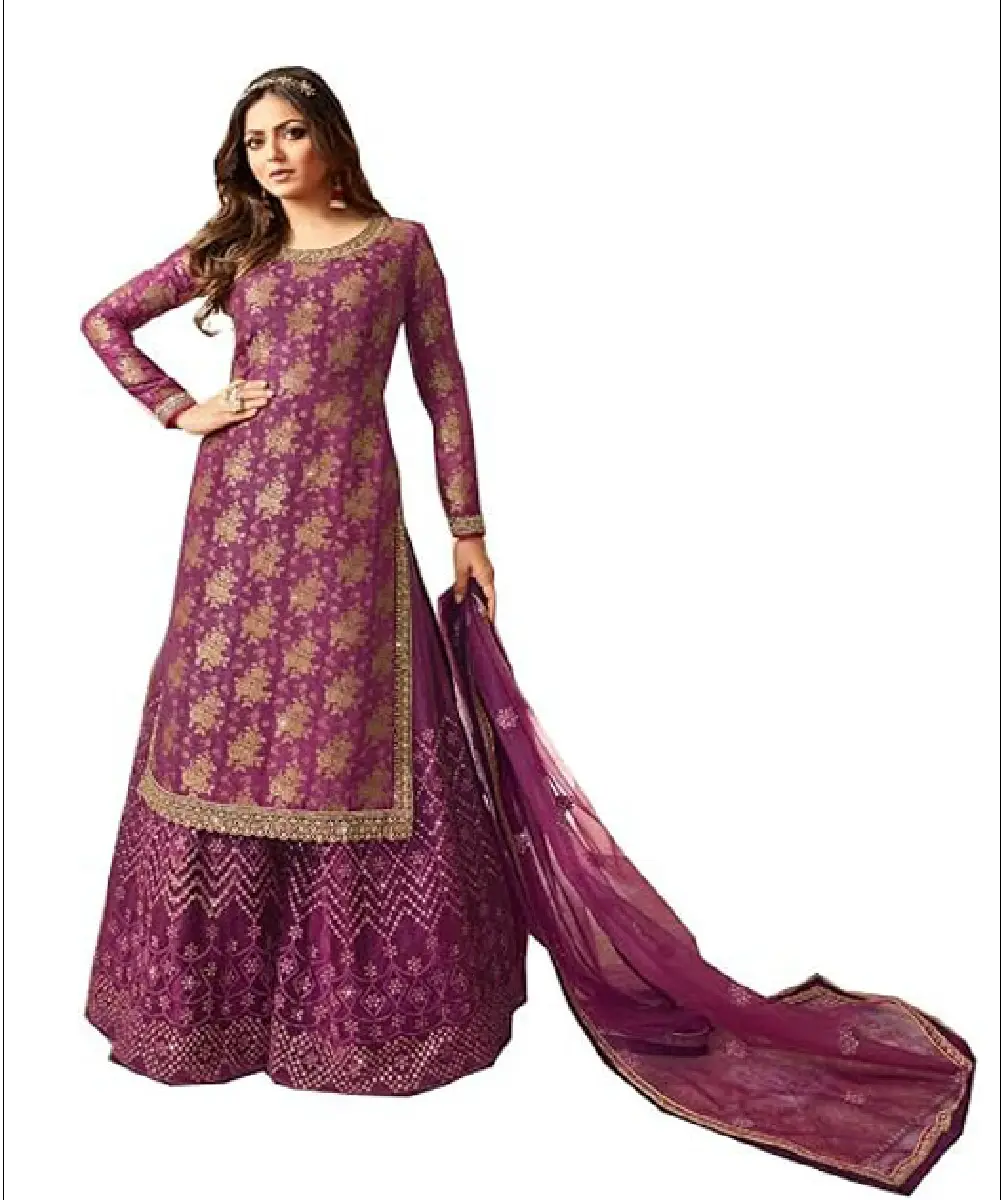 A woman modeling a purple ethnic suit set, featuring a Dola Jacquard embroidered top, a heavily embroidered net bottom, and a matching embroidered net dupatta.