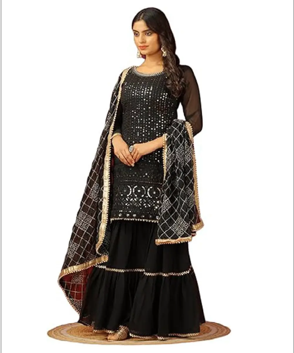 A woman modeling a grey faux georgette sharara palazzo suit featuring heavy embroidery, fancy lace details, and a matching embroidered dupatta.