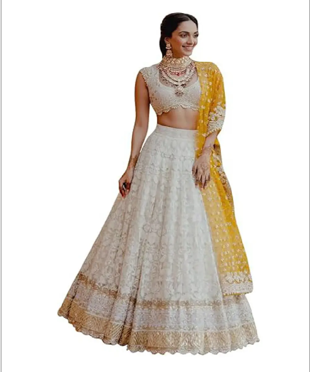 A woman modeling a grey faux georgette sharara palazzo suit featuring heavy embroidery, fancy lace details, and a matching embroidered dupatta.