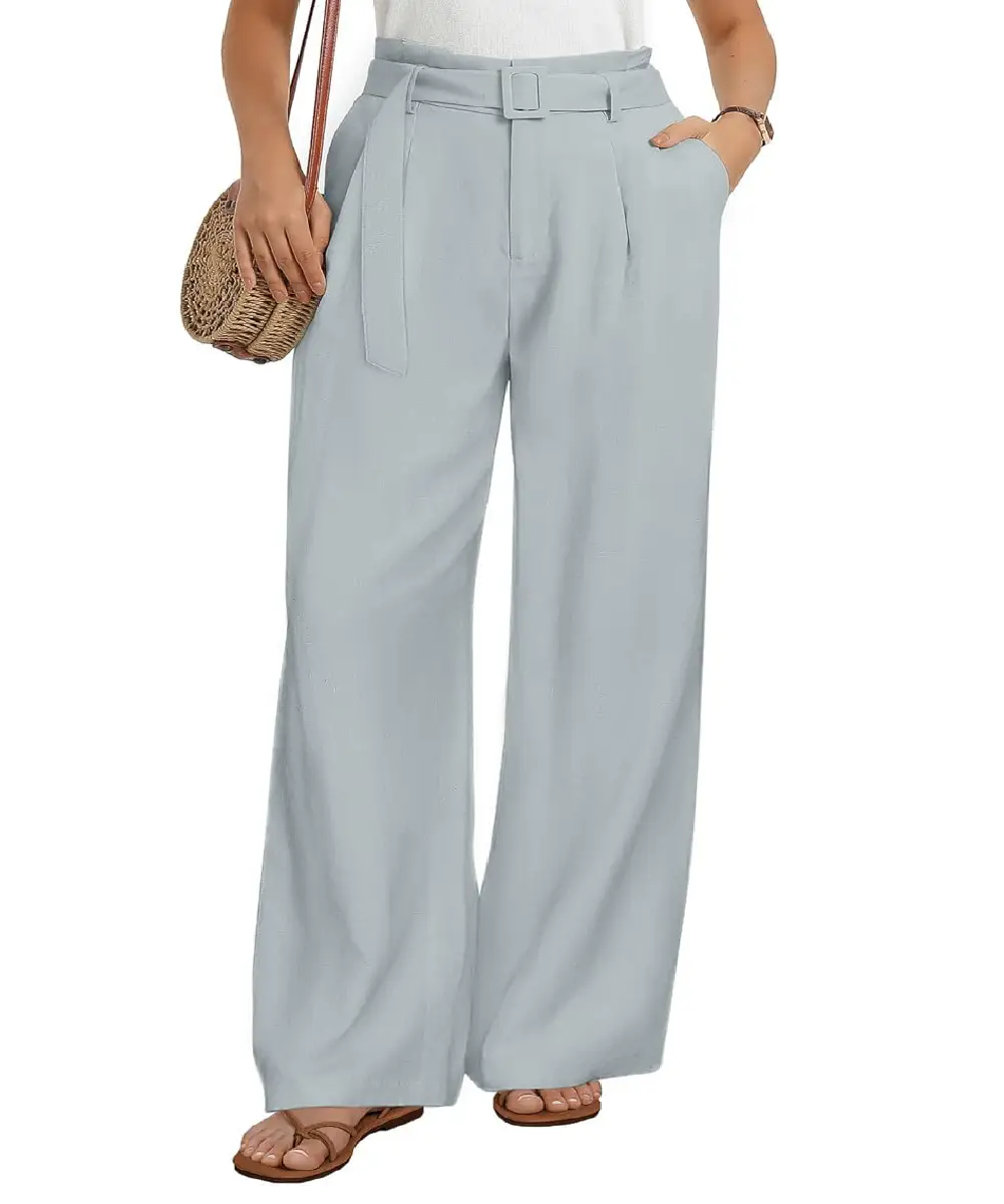 A woman wearing light blue high-waisted wide-leg paperbag pants with a decorative belt and side pockets, styled for a casual yet elegant look.