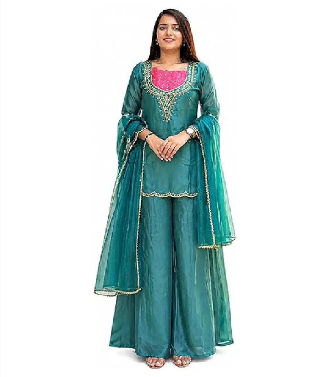 A woman modeling a pastel pink, calf-length rayon kurta featuring a delicate floral print, 3/4 sleeves, and a matching dupatta.