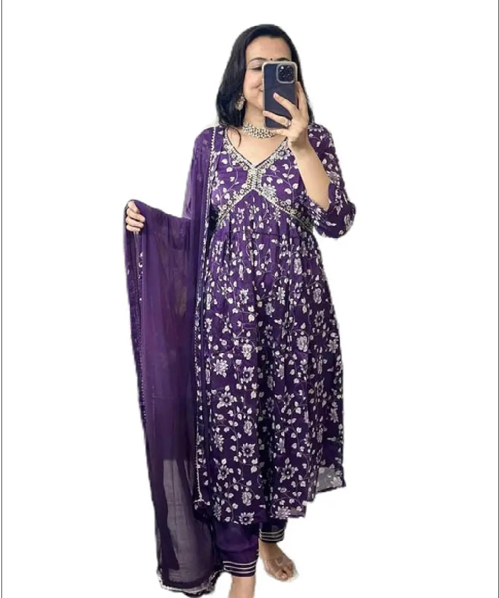 A woman posing in a mirror wearing a purple Alia cut kurta made of viscose rayon fabric, featuring three-quarter sleeves and calf-length styling.