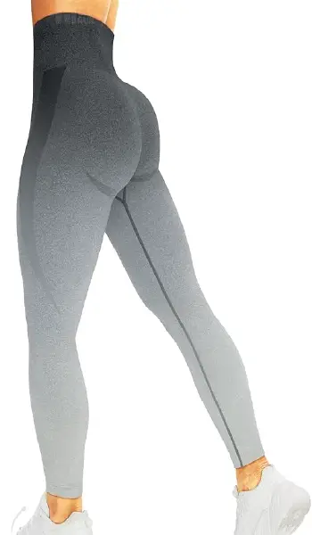 A woman from a back-side view modeling seamless, high-waisted ombre leggings in grey shades with thigh and glute contour shading.