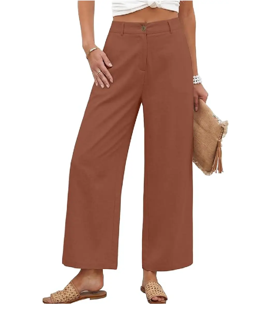 A woman wearing terracotta-colored casual palazzo pants made from a linen blend, styled with a white top and woven sandals.