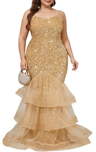 A plus-size model wearing a shimmering, floor-length gold sequin gown with a sleeveless suspender-style top and a layered, ruffled mesh fishtail hem.
