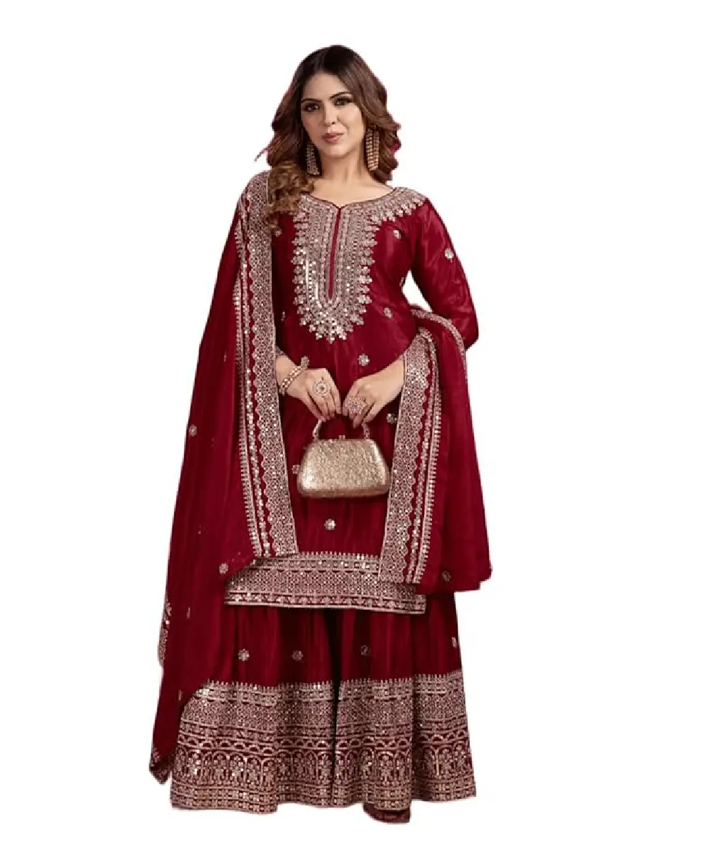 A model is wearing a dark maroon colored sharara suit with heavy embroidery and sequence work.