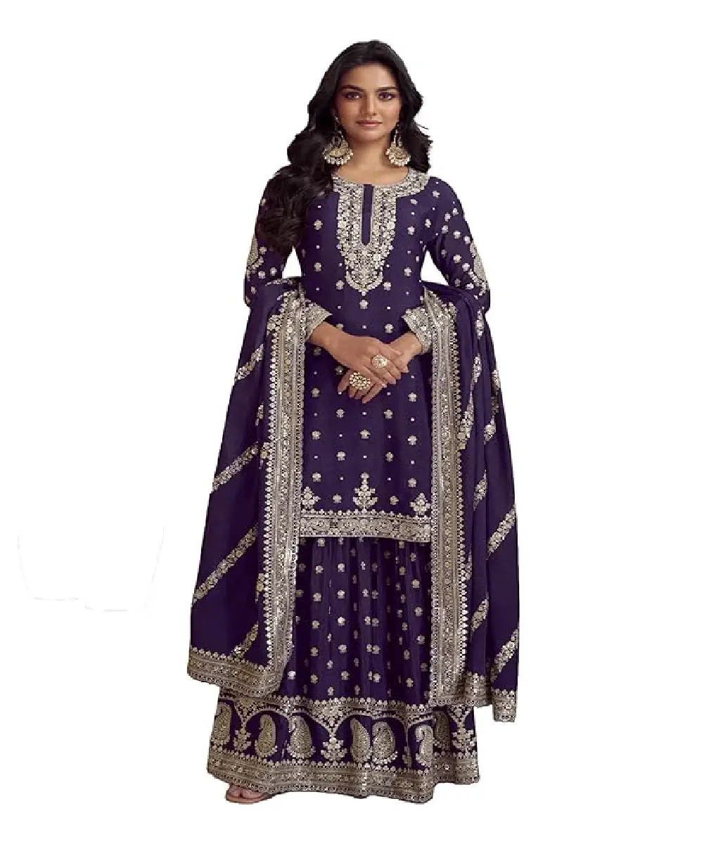 A model is wearing a dark purple heavy silk salwar suit with embroidery, sequences and coding work.