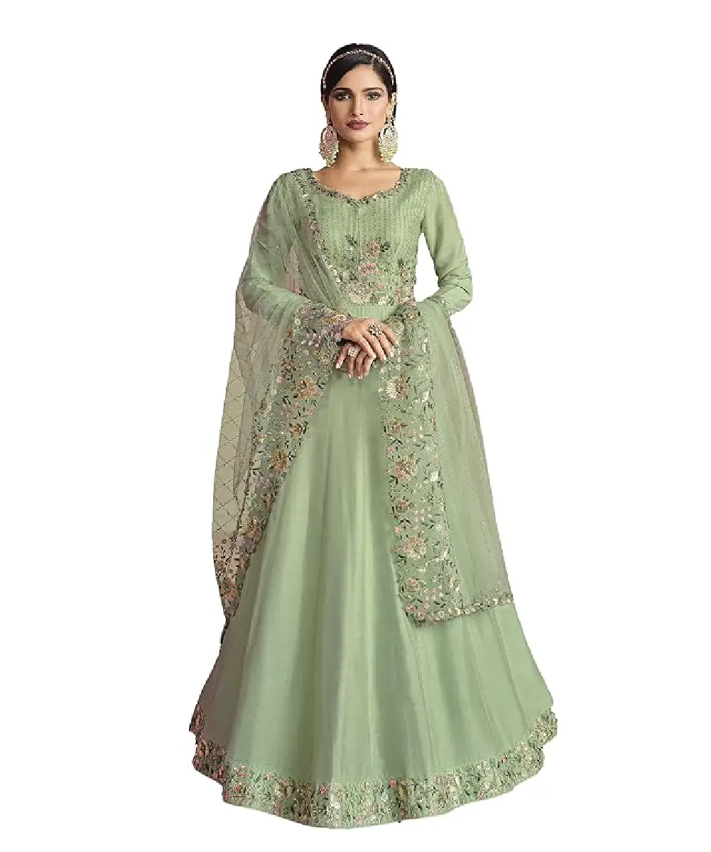 A model is wearing a light green silk salwar kameez with embroidery, sequins and lace work.