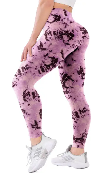 A woman modeling high-waisted, tie-dye print leggings in shades of purple and black.