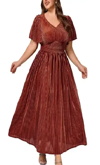 A plus-size model wearing a rust-colored, velvet-textured long dress with short flared sleeves, a V-neckline, and an elasticated high-waist design.