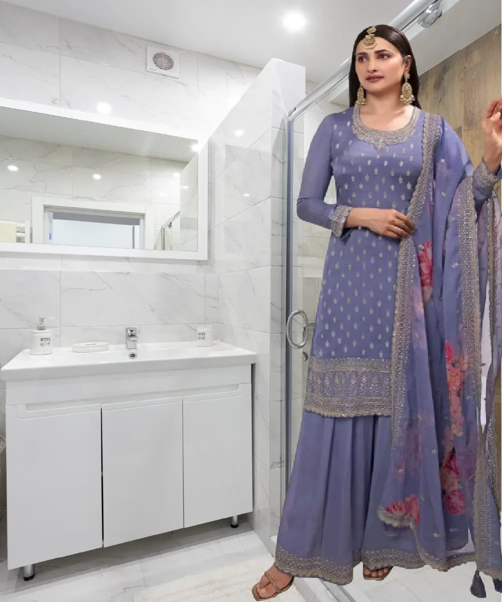 A model is wearing a purple chinon salwar kameez and palazzo set with digital print and heavy embroidery.