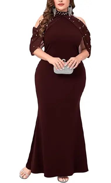 A plus-size model wearing an elegant floor-length maroon bodycon dress with a pearl-encrusted halter neckline and pearl-studded cold-shoulder chiffon sleeves.