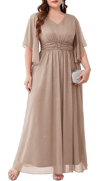 A plus-size model wearing a flowing, taupe-colored floor-length gown crafted from shimmer mesh fabric, featuring a V-neckline, butterfly sleeves, and a pleated empire waist.