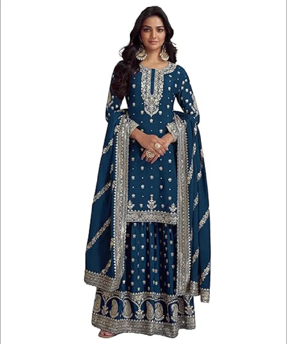 A woman wearing a beautiful teal blue heavy silk salwar suit featuring intricate embroidery, sequence work, and matching dupatta.