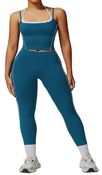 A woman modeling a blue 2-piece athletic yoga set featuring a spaghetti strap backless tank top and matching high-rise leggings with contrast detailing.