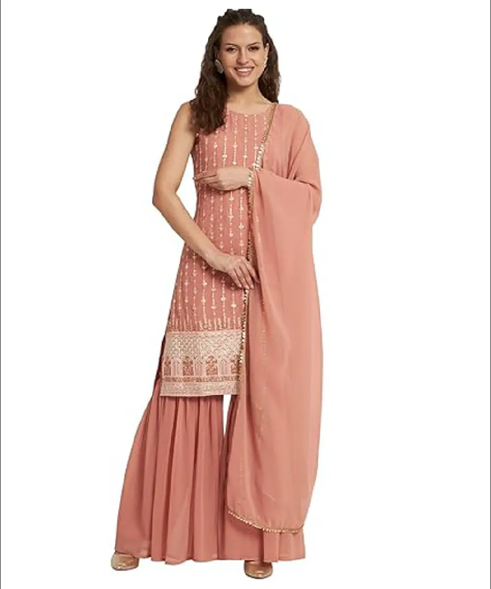 A model is wearing a peach-colored georgette straight kurta, sharara, and matching dupatta.