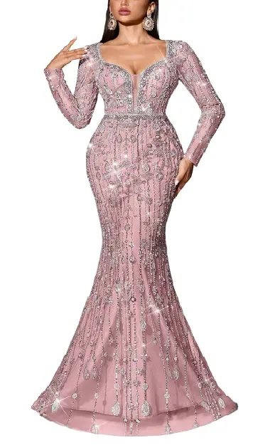 A model wearing a floor-length, long-sleeved pink mermaid gown completely covered in dense, light-reflecting sequins and beads, featuring a bold V-neckline.