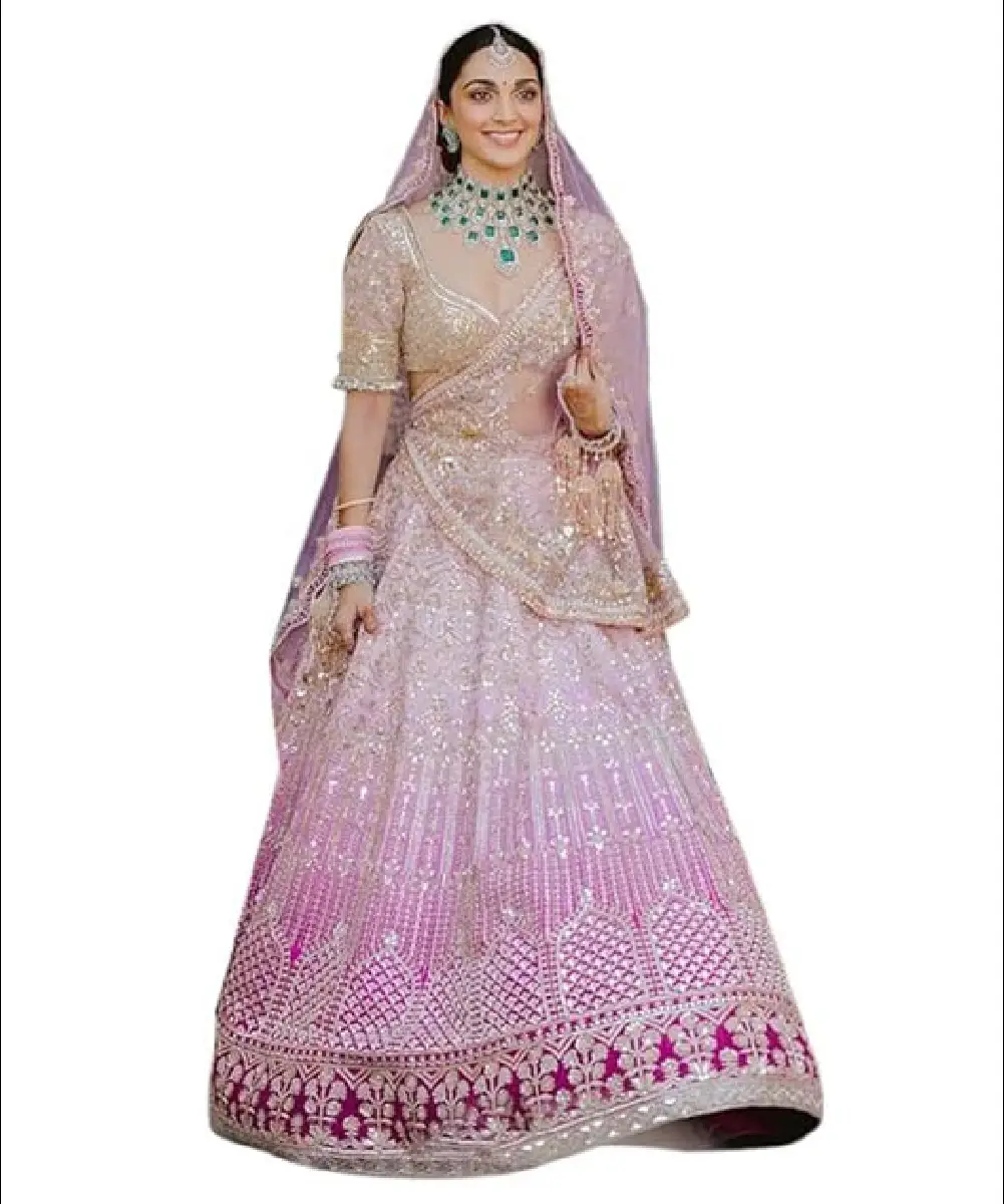 A model is wearing a beautiful pink lehenga choli and net dupatta with heavy embroidery and sequence work.