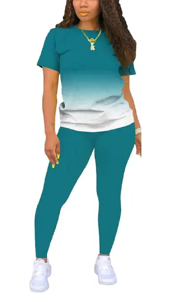 A woman modeling a grey 2-piece outfit consisting of a solid, short-sleeve crew neck pullover top and matching long leggings.