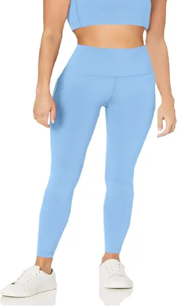 A woman modeling sky blue high-rise, full-length workout leggings featuring a comfortable elastic waistband.
