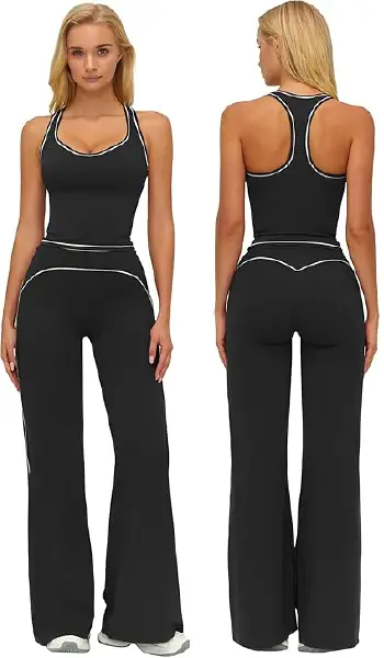 A woman modeling a black 2-piece workout set consisting of a racerback tank top with built-in bra and matching high-waisted wide-leg yoga pants with contrast stitching.