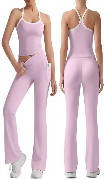 A woman modeling a light pink 2-piece workout set featuring a cross-back crop tank top and matching high-waisted flare leggings with side pockets.