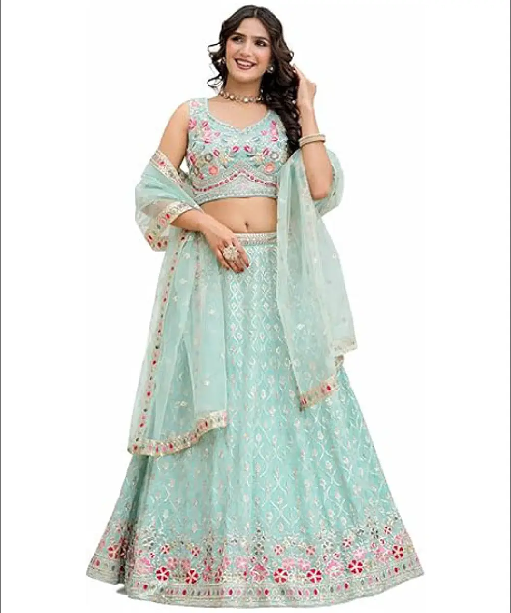 A woman wearing a light green georgette lehenga choli set featuring intricate embroidery and sequence work, paired with a matching net dupatta.