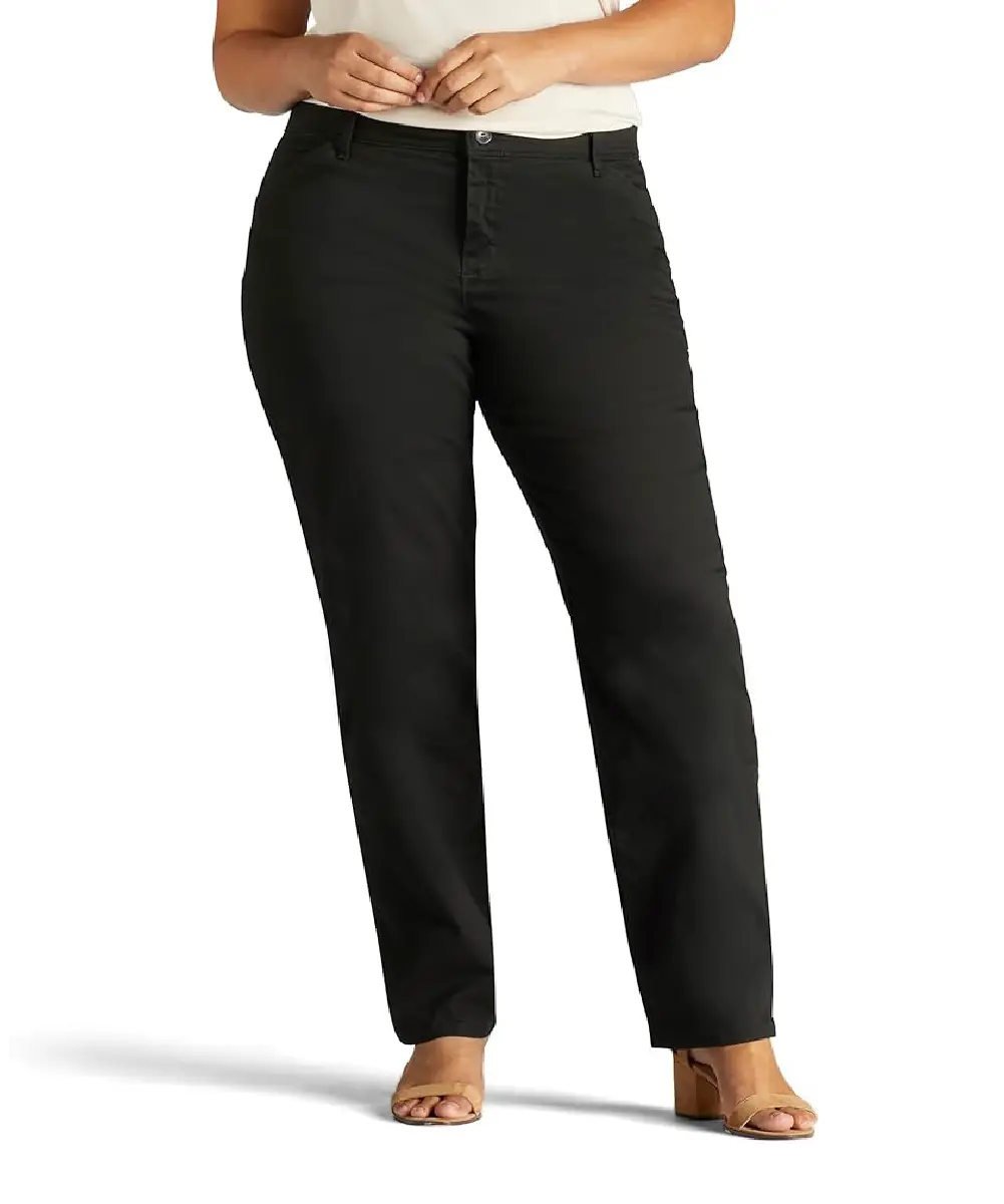 A woman wearing solid black, mid-rise, relaxed-fit trousers with a flat front design and zip-fly closure.