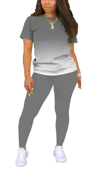A woman modeling a grey 2-piece outfit consisting of a solid, short-sleeve crew neck pullover top and matching long leggings.