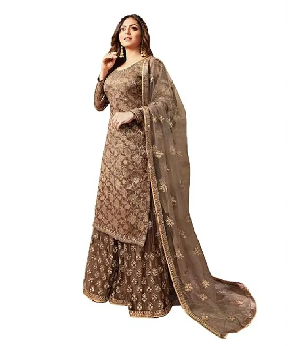 A woman wearing a brown readymade salwar kameez with a dola silk top, heavy net sharara, and a matching net dupatta.