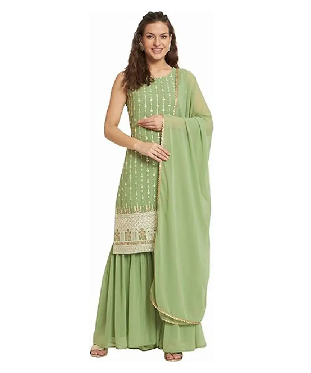 A woman wearing a light green georgette straight kurta paired with a matching sharara and a dupatta embellished with lace and tassels.