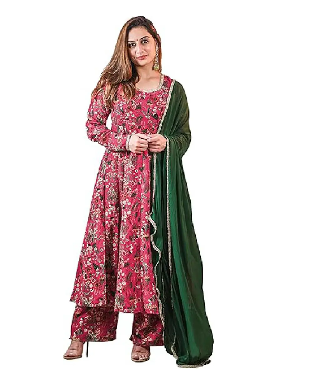A woman wearing a pink Anarkali-style kurta and palazzo set featuring a vibrant digital floral print, paired with a solid dark green chiffon dupatta.