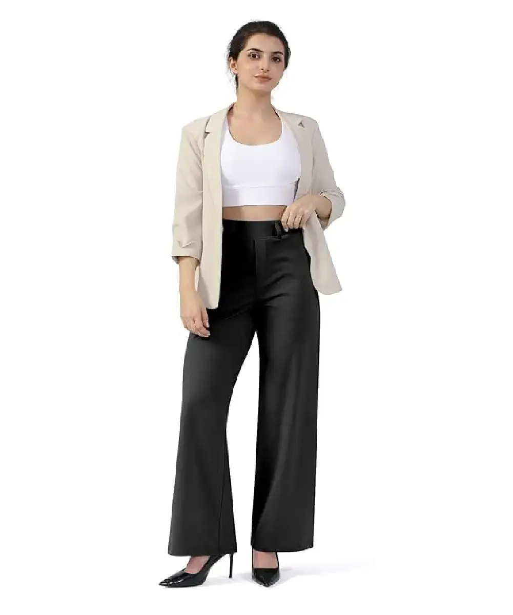 A woman wearing black high-waisted wide-leg dress pants with side pockets and a belt, styled for a professional office look.