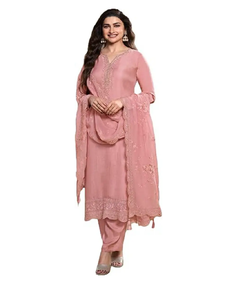 A woman wearing a dusty pink natural crepe salwar suit featuring intricate embroidery work, paired with a matching Tabby Silk dupatta.