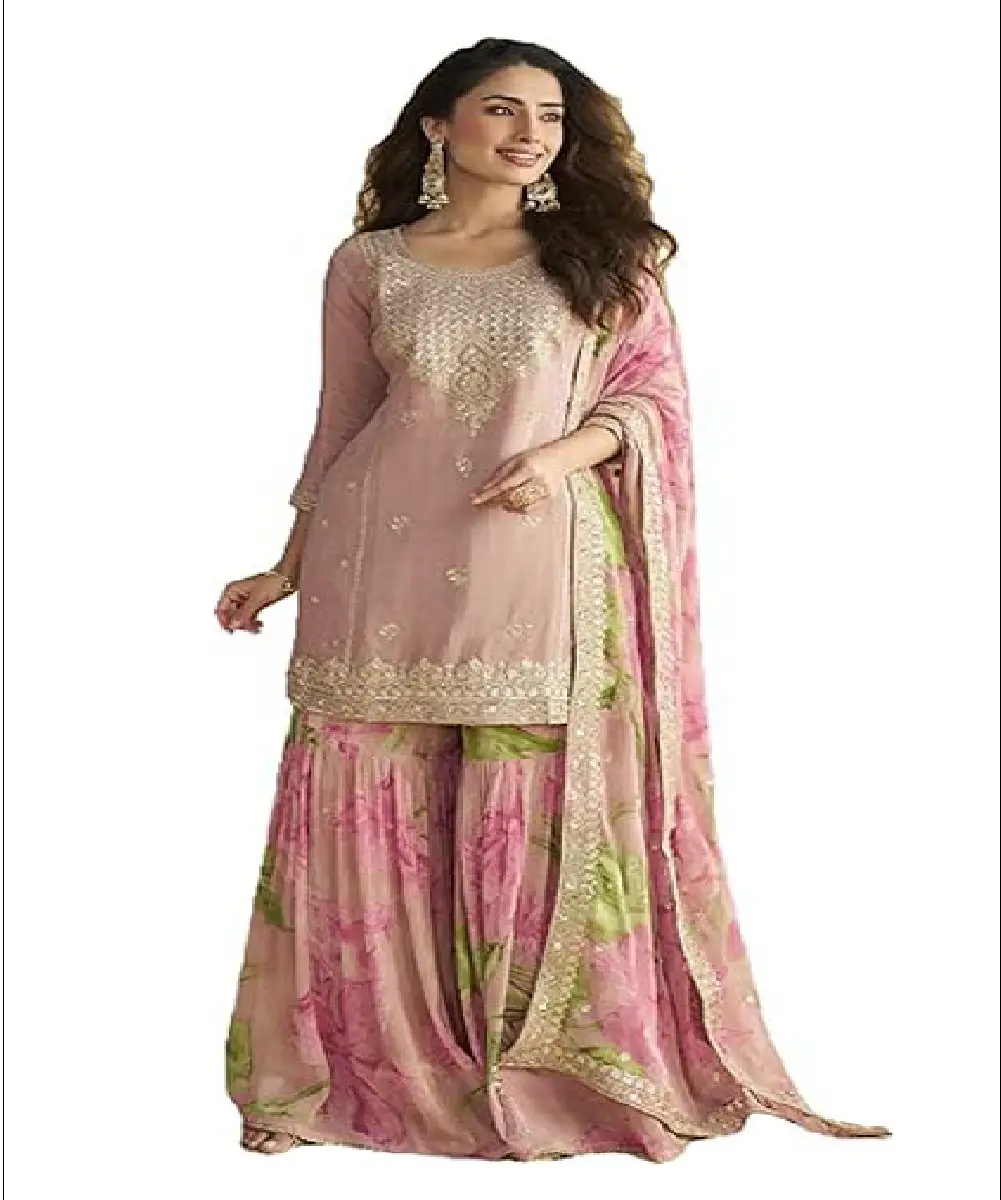 A woman wearing a dusty pink real Chinon sharara suit with intricate sequin embroidery on the top and a floral printed heavy Chinon bottom and dupatta.